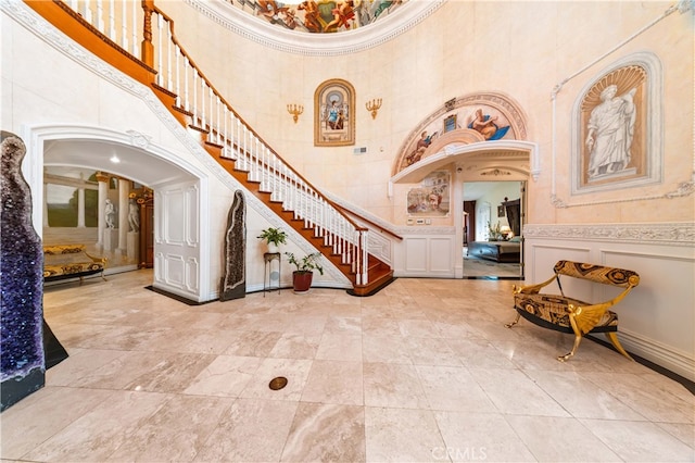 1782 Chota Rd, La Habra Heights, CA 90631 - entryway with a towering ceiling, stairs, arched walkways, and a decorative wall