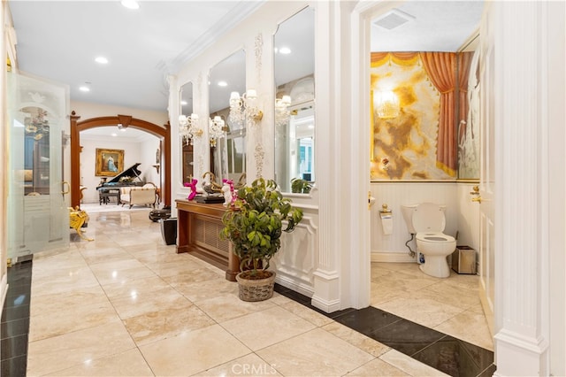 1782 Chota Rd, La Habra Heights, CA 90631 - hall featuring arched walkways, decorative columns, crown molding, recessed lighting, and wainscoting