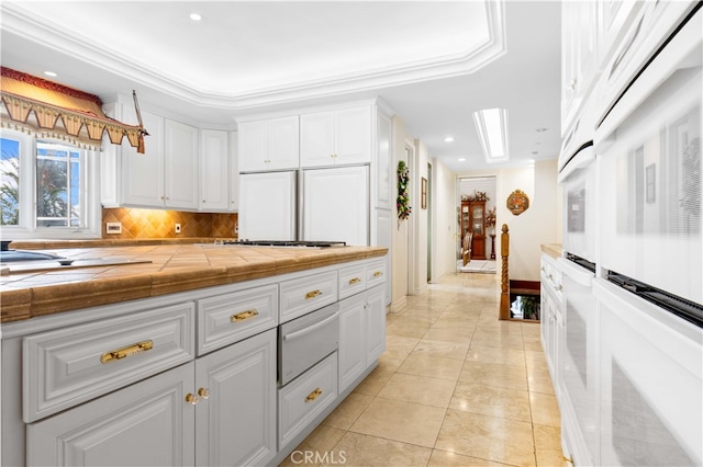 1782 Chota Rd, La Habra Heights, CA 90631 - kitchen with a warming drawer, white cabinets, tile counters, recessed lighting, and light tile patterned floors