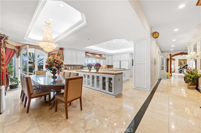 1782 Chota Rd, La Habra Heights, CA 90631 - dining area with a tray ceiling, a chandelier, recessed lighting, and baseboards