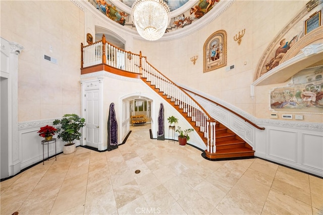 1782 Chota Rd, La Habra Heights, CA 90631 - entrance foyer with a towering ceiling, a chandelier, stairs, ornamental molding, and a decorative wall