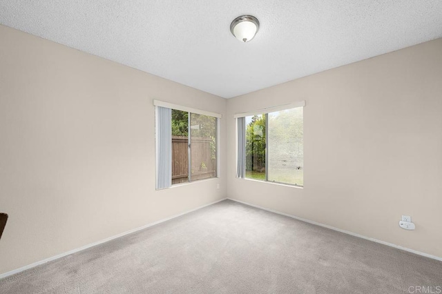 spare room with carpet flooring and baseboards