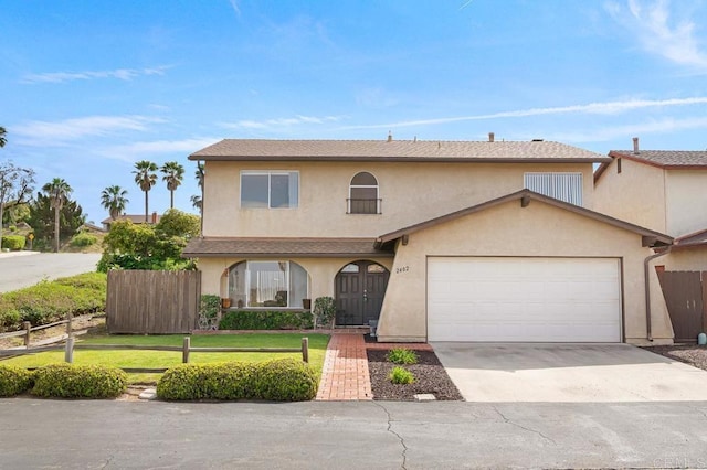 view of front facade featuring stucco siding, a garage, and concrete driveway