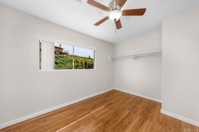 spacious closet featuring wood finished floors and a ceiling fan