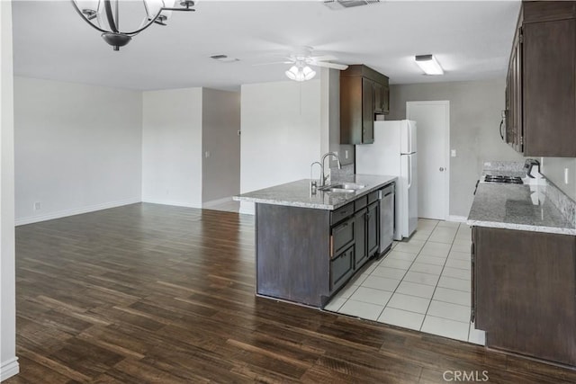 kitchen featuring a sink, stainless steel appliances, and dark brown cabinetry