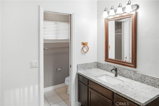 bathroom featuring toilet, vanity, and tile patterned floors