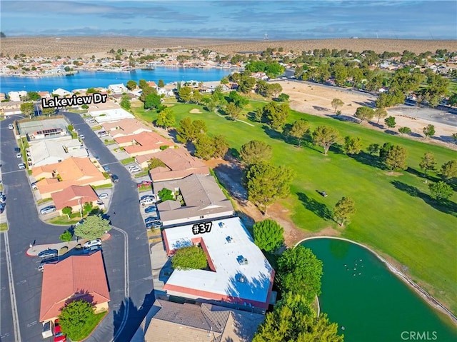aerial perspective of suburban area with a large body of water and a golf course