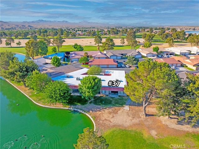 aerial view of residential area featuring a water and mountain view