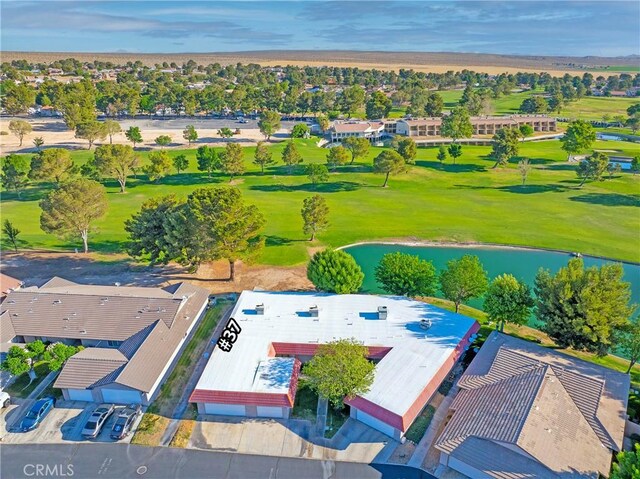 drone / aerial view of a golf course and a large body of water