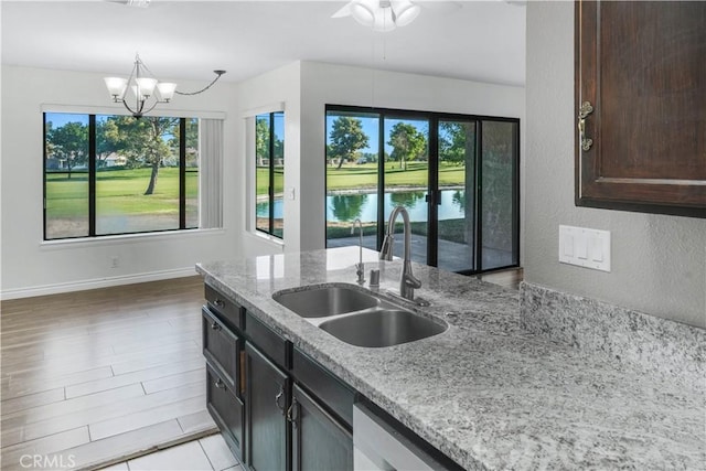 27535 Lakeview Dr Unit 37, Helendale, CA 92342 - kitchen with plenty of natural light, light stone counters, ceiling fan, and a textured wall