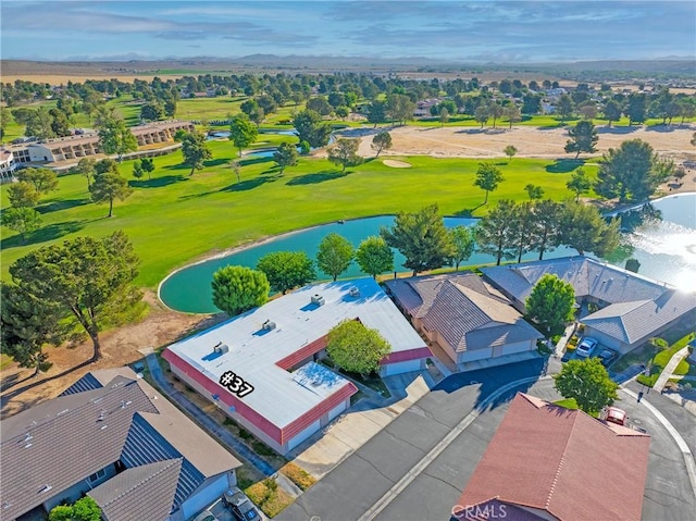 drone / aerial view of a large body of water and a local golf course