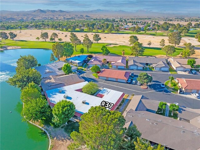 aerial view of residential area with a water and mountain view and a local golf course