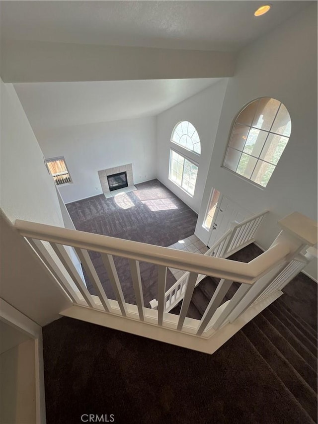 12418 Firefly Way, Victorville, CA 92392 - stairway with carpet floors, lofted ceiling, a fireplace, and baseboards