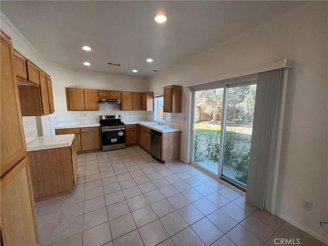 12418 Firefly Way, Victorville, CA 92392 - kitchen featuring appliances with stainless steel finishes, under cabinet range hood, brown cabinets, light tile patterned floors, and recessed lighting