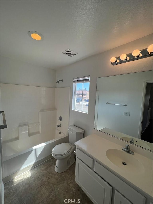 12418 Firefly Way, Victorville, CA 92392 - bathroom with toilet, vanity,  shower combination, and a textured ceiling