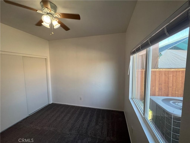 12418 Firefly Way, Victorville, CA 92392 - unfurnished bedroom featuring dark carpet, a ceiling fan, and a closet