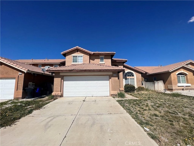 12418 Firefly Way, Victorville, CA 92392 - view of front of property featuring stucco siding, concrete driveway, a tile roof, and a garage