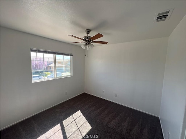 12418 Firefly Way, Victorville, CA 92392 - unfurnished room with dark colored carpet, a ceiling fan, and baseboards