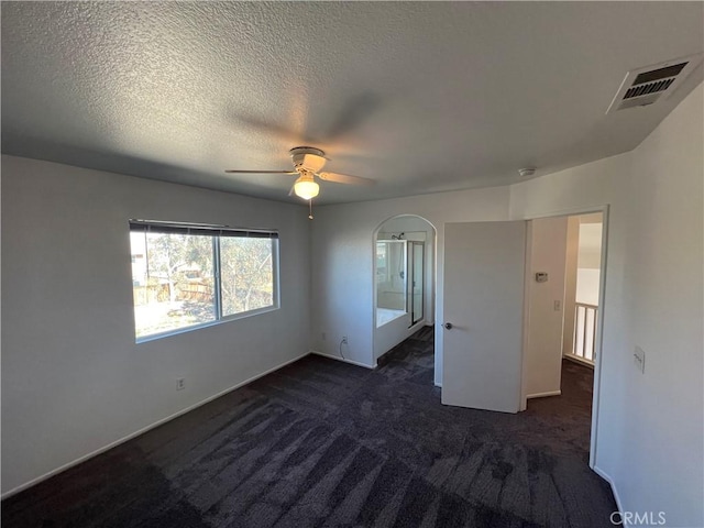 12418 Firefly Way, Victorville, CA 92392 - unfurnished bedroom featuring dark carpet, baseboards, and ceiling fan