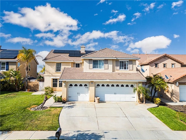 traditional-style home with stucco siding, an attached garage, driveway, solar panels, and a tile roof