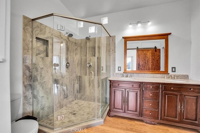 7565 Sherman Hoyt Ave Unit 29, Palms, CA 92277 - full bath with wood finished floors, a stall shower, toilet, and double vanity
