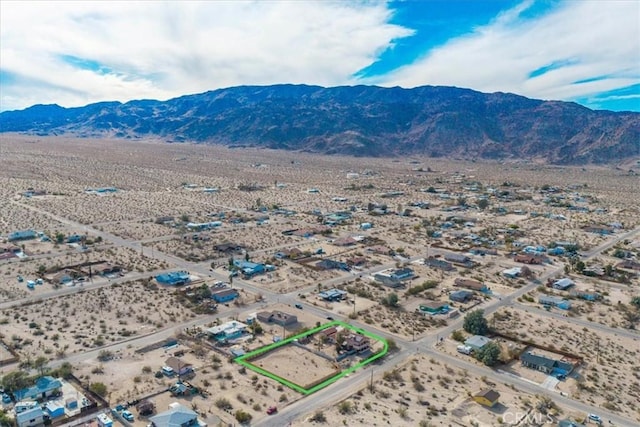 7565 Sherman Hoyt Ave Unit 29, Palms, CA 92277 - aerial view of property's location featuring a mountain backdrop, property boundaries highlighted, and a desert landscape