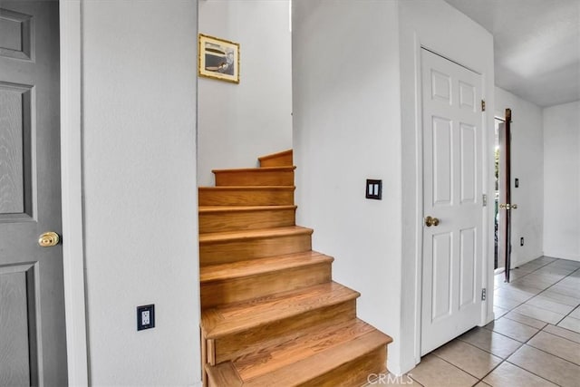 7565 Sherman Hoyt Ave Unit 29, Palms, CA 92277 - stairs featuring tile patterned floors