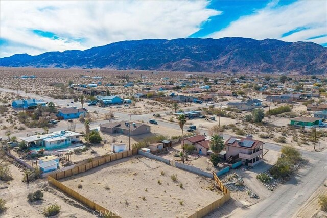 7565 Sherman Hoyt Ave Unit 29, Palms, CA 92277 - aerial view of residential area featuring a mountain backdrop and a desert landscape