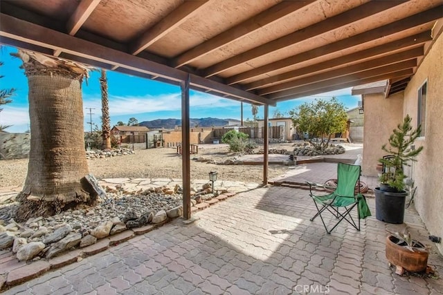 7565 Sherman Hoyt Ave Unit 29, Palms, CA 92277 - view of patio with fence and an outbuilding