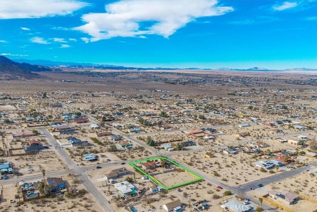 7565 Sherman Hoyt Ave Unit 29, Palms, CA 92277 - aerial view of property's location with a mountain backdrop, property boundaries highlighted, and a desert landscape