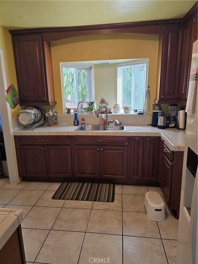 519 N Sloan Ave, Compton, CA 90221 - kitchen featuring a sink, tile countertops, and healthy amount of natural light
