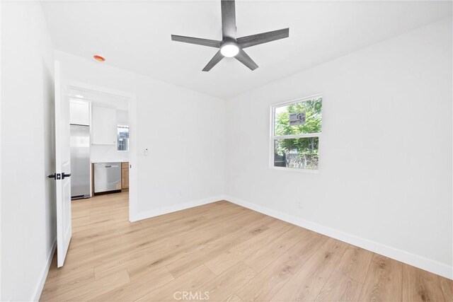 9613 Wilmington Ave, Los Angeles, CA 90002 - unfurnished room featuring light wood finished floors, a ceiling fan, and baseboards