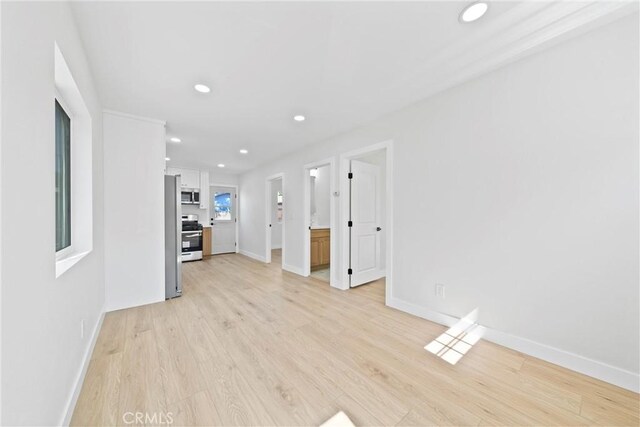 9613 Wilmington Ave, Los Angeles, CA 90002 - unfurnished living room featuring light wood-type flooring, baseboards, and recessed lighting