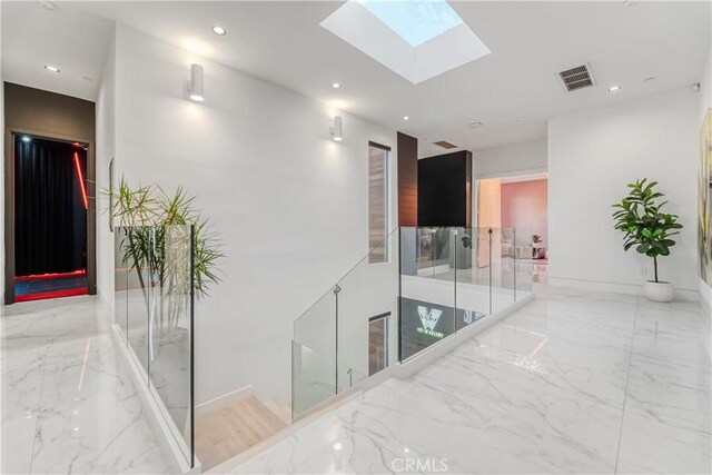 4841 Alonzo Ave, Encino, CA 91316 - corridor featuring marble tiled floors, a skylight, recessed lighting, and baseboards