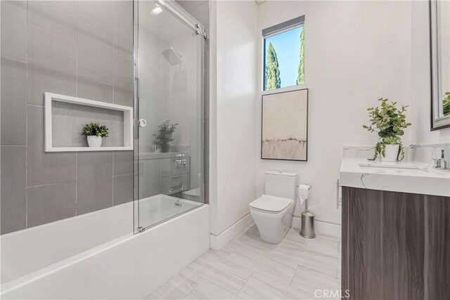 4841 Alonzo Ave, Encino, CA 91316 - bathroom featuring toilet, baseboards, vanity, marble finish flooring, and shower / bath combination with glass door