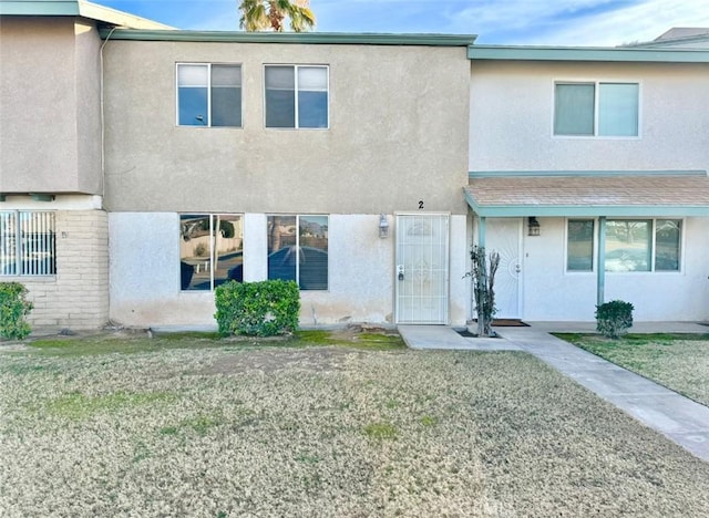 1060 N Lovekin Blvd Unit 2, Blythe, CA 92225 - multi unit property featuring stucco siding and a front lawn