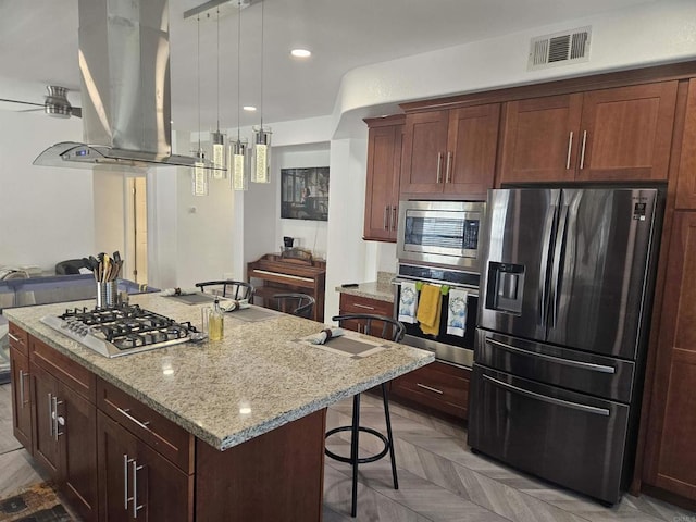 43075 Corte Fresca, Temecula, CA 92592 - kitchen with stainless steel appliances, island exhaust hood, a breakfast bar area, open floor plan, and a center island