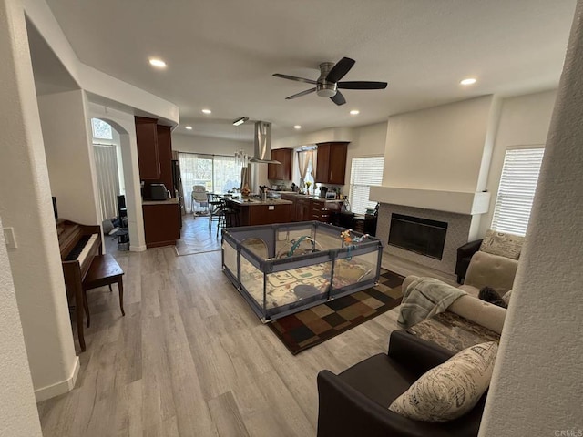 43075 Corte Fresca, Temecula, CA 92592 - living area with a ceiling fan, recessed lighting, light wood-style floors, and a glass covered fireplace