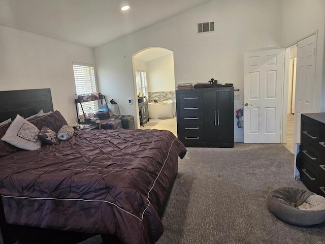 43075 Corte Fresca, Temecula, CA 92592 - carpeted bedroom with arched walkways, lofted ceiling, ensuite bathroom, and recessed lighting