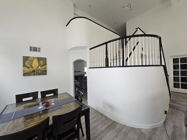 43075 Corte Fresca, Temecula, CA 92592 - dining space featuring arched walkways, a towering ceiling, and wood finished floors
