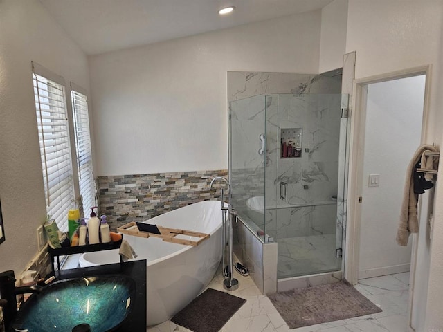43075 Corte Fresca, Temecula, CA 92592 - full bathroom with marble look tile flooring, a freestanding bath, a marble finish shower, tile walls, and wainscoting