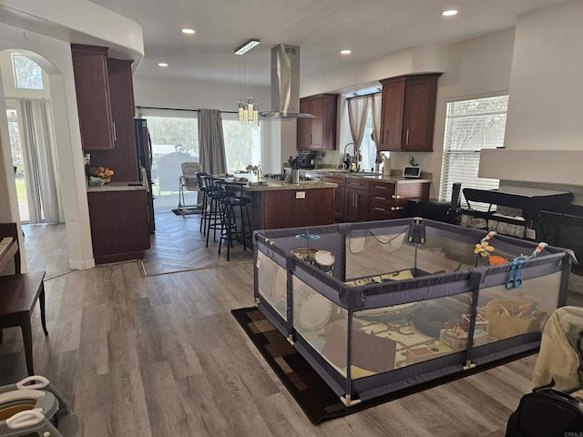 43075 Corte Fresca, Temecula, CA 92592 - kitchen featuring exhaust hood, a kitchen island, healthy amount of natural light, wood finished floors, and recessed lighting