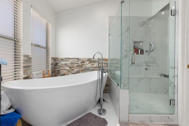 43075 Corte Fresca, Temecula, CA 92592 - bathroom featuring a marble finish shower, tile walls, a freestanding tub, marble look tiles, and wainscoting