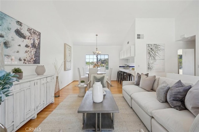 1924 Mathews Ave Unit B, Redondo Beach, CA 90278 - living room with a chandelier, light wood-type flooring, and high vaulted ceiling