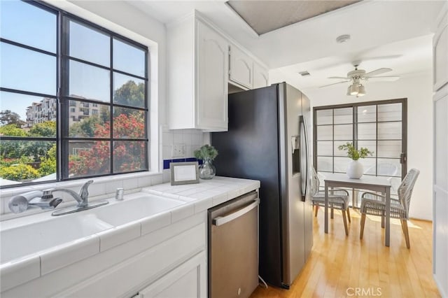 1924 Mathews Ave Unit B, Redondo Beach, CA 90278 - kitchen featuring stainless steel appliances, tile countertops, white cabinetry, a ceiling fan, and a sink