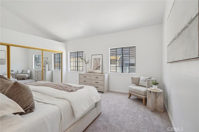 1924 Mathews Ave Unit B, Redondo Beach, CA 90278 - bedroom with light carpet, multiple windows, vaulted ceiling, baseboards, and a closet