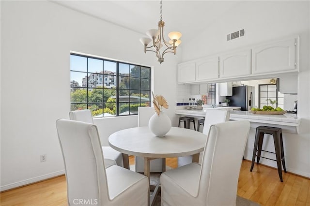 1924 Mathews Ave Unit B, Redondo Beach, CA 90278 - dining room featuring a chandelier, light wood finished floors, baseboards, and high vaulted ceiling