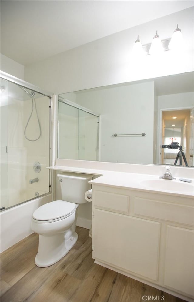 5538 Katrina Pl, Palmdale, CA 93552 - full bathroom with toilet, wood finished floors, vanity, and shower / bath combination with glass door