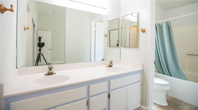5538 Katrina Pl, Palmdale, CA 93552 - bathroom with toilet, double vanity, shower / bath combo with shower curtain, and wood finished floors