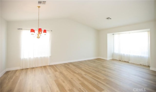 5538 Katrina Pl, Palmdale, CA 93552 - unfurnished living room with a chandelier, light wood-style floors, vaulted ceiling, and baseboards